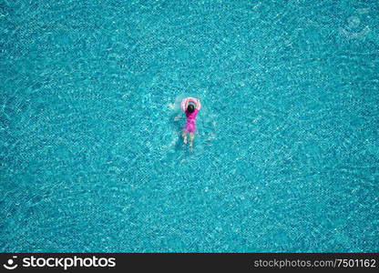 Top view of girl swimming in the pool.