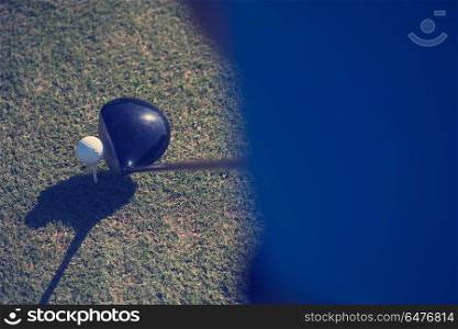 top view of golf club and ball in grass on course preparing for shot. top view of golf club and ball in grass
