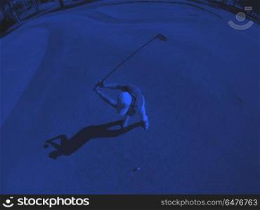 top view of golf player hitting shot. top view of golf player hitting shot with club on course at beautiful morning duo tone