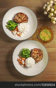 Top view of grilled chicken served with steamed rice and vegetables. delicious grilled chicken