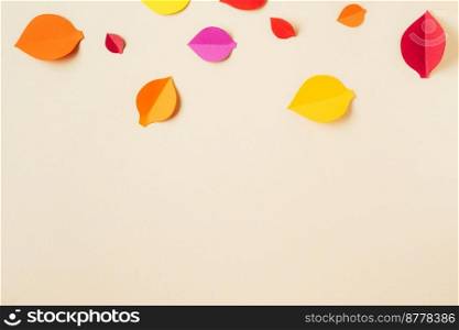 Top view of handmade paper autumn leaves with copy space. School time. Paper art and handcrafting. Autumn season. Handmade autumn leaves on light yellow background