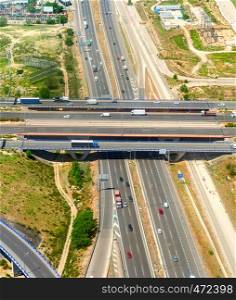 Top view of highway junction infrastructure, transport traffic on bridge, trucks, car parking, Istanbul, Turkey
