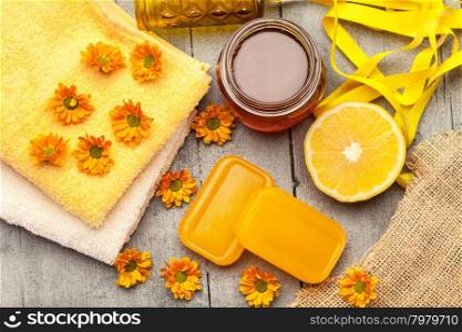 Top view of honey soap with lemon over wooden table