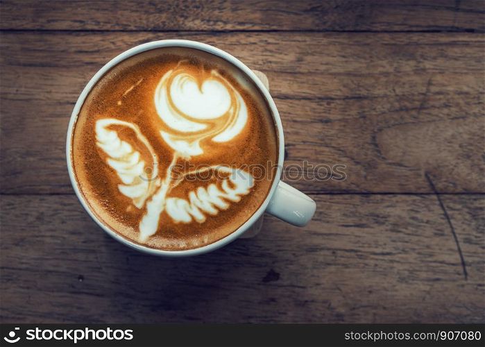 Top view of hot coffee on the wooden table background, drink concept
