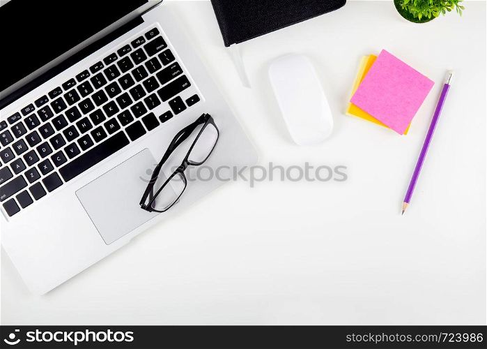 Top view of laptop computer with open display screen monitor, diary and mouse and notepad, glasses and pencil isolated on white background, notebook or netbook with keyboard, communication technology concept.