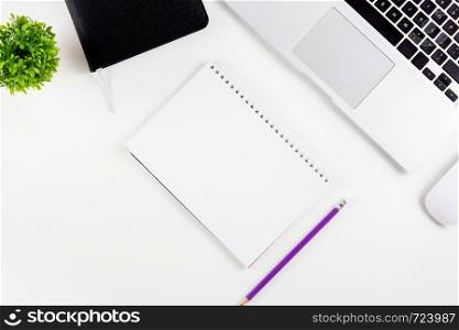 Top view of laptop computer with open display screen monitor, diary and mouse and notepad, glasses and pencil isolated on white background, notebook or netbook with keyboard, communication technology concept.