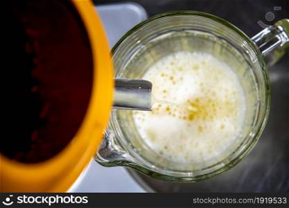 top view of lemon juice filling jug from juicer