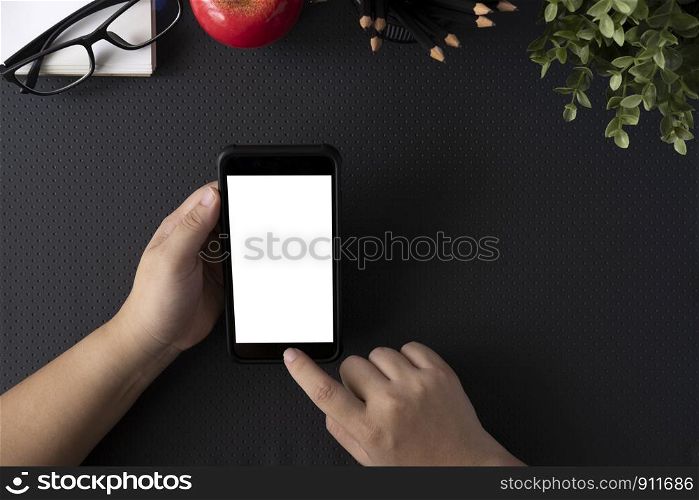 Top view of man holding blank screen smartphone. Copy space and mockup.