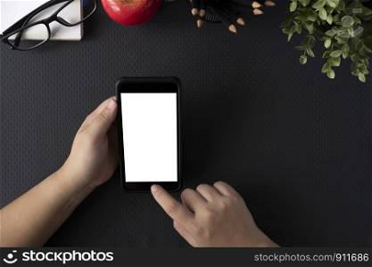 Top view of man holding blank screen smartphone. Copy space and mockup.