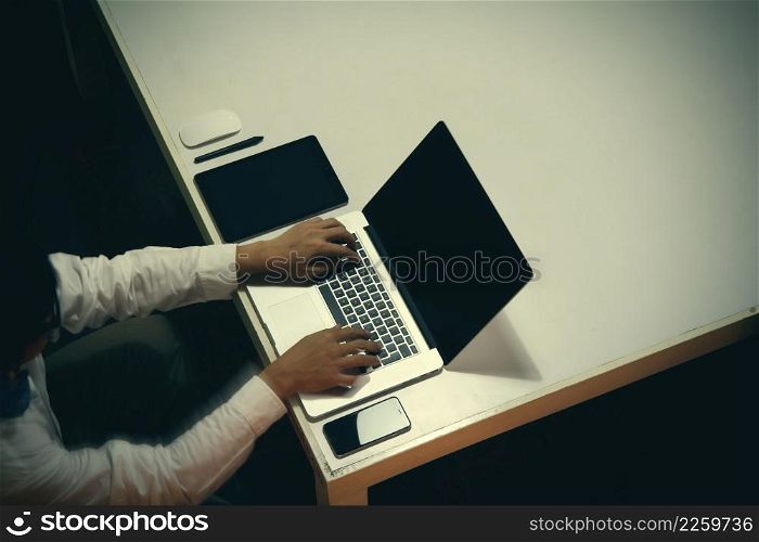 top view of man working with business documents on office table with digital tablet and man working with smart laptop computer