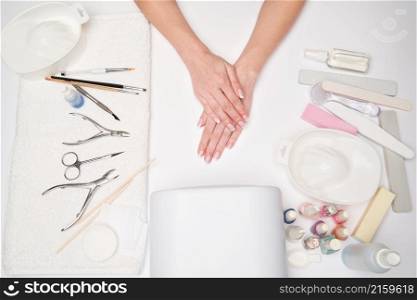 top view of manicure tools and Woman Preparing her hands for getting manicure procedure.. top view of manicure tools and Woman Preparing her hands for getting manicure procedure