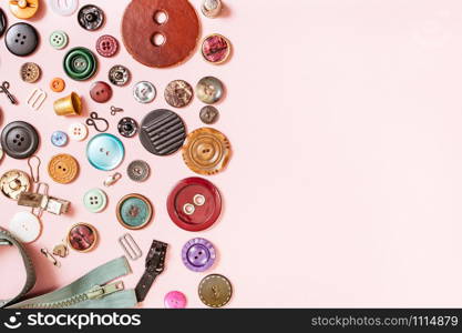 top view of many sewing objects on pink background with blank copyspace