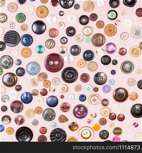 top view of many various buttons on pink background