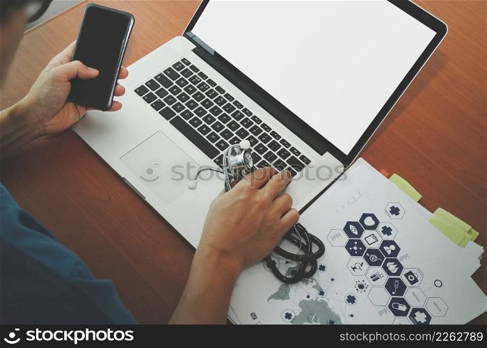 top view of Medicine doctor hand working with modern computer and blank screen on wooden desk as medical concept