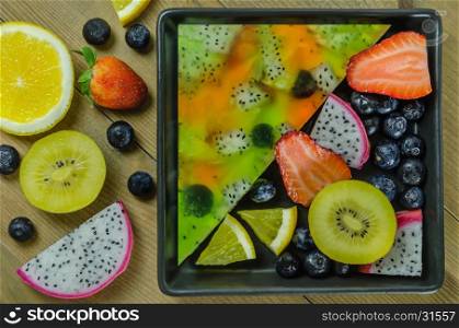 Top view of mixed jelly fruits ( strawberry, blueberry, kiwi, orange, dragon fruit )