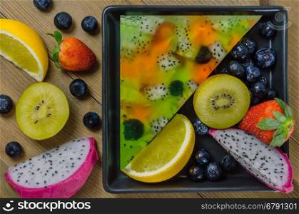 Top view of mixed jelly fruits ( strawberry, blueberry, kiwi, orange, dragon fruit )