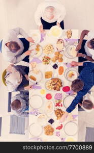 top view of modern multiethnic muslim family enjoying eating iftar dinner together during a ramadan feast at home