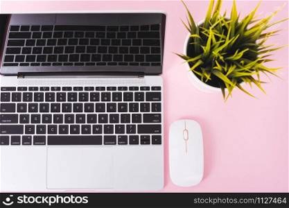 Top view of modern technology smart phone mobile and computer laptop on pink background with copy space