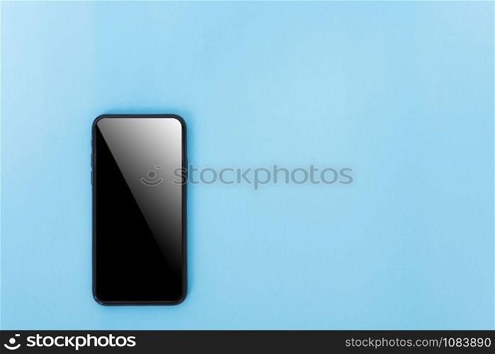 Top view of modern technology smart phone mobile on blue background with copy space