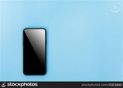 Top view of modern technology smart phone mobile on blue background with copy space