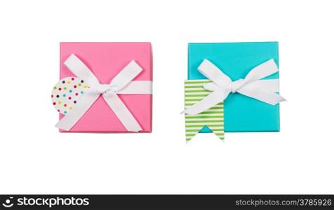 Top view of new pink and aqua color wrapped gift boxes and white bows isolated on white