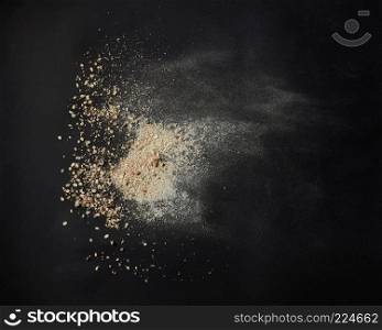 Top view of oat powder over black background. powder of oats
