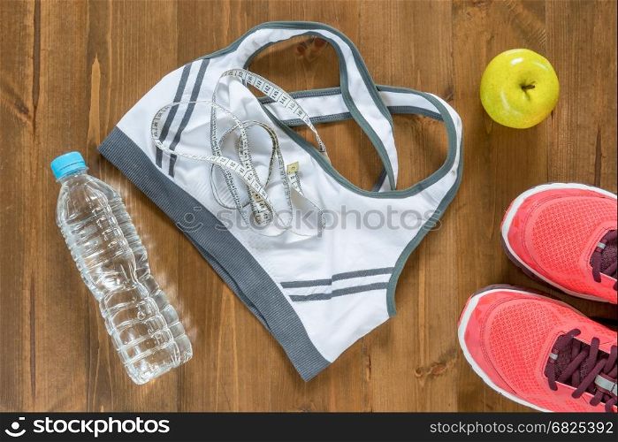 top view of objects and clothing for sports close up on the wooden floor