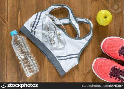 top view of objects and clothing for sports close up on the wooden floor