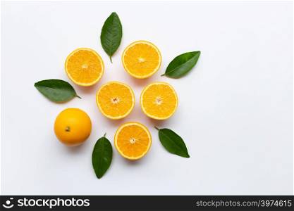 Top view of orange fruits with green leaves isolated on white background.