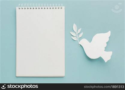 top view of paper dove with notebook. Resolution and high quality beautiful photo. top view of paper dove with notebook. High quality and resolution beautiful photo concept