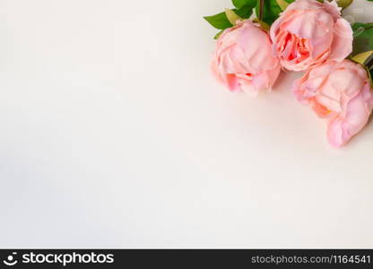 Top view of pink Peonies artificial flowers on white blank background