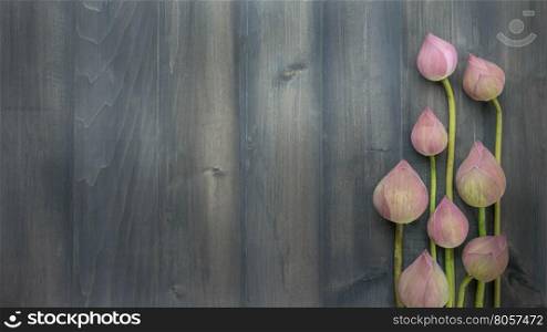 top view of pink water lily over wooden background, Free space for text