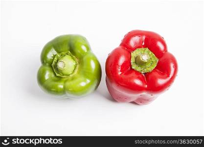 Top view of red and green fresh bell peppers over white background