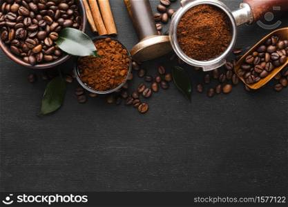 top view of roasted coffee beans scattered from a ceramic cup on coffee beans background