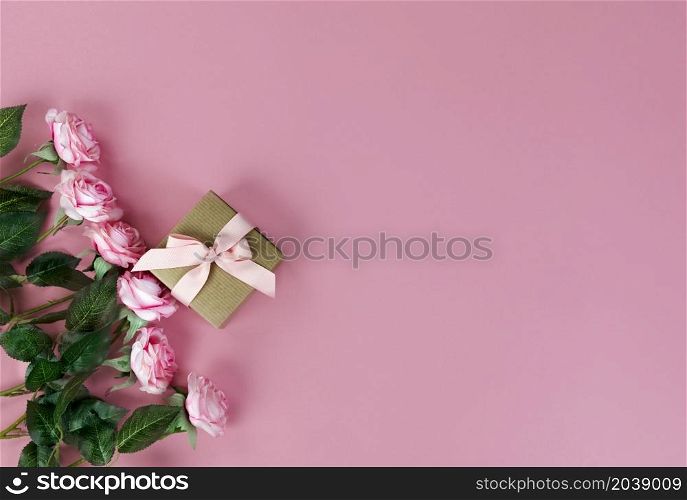 Top view of roses on pink background for Mothers Day holiday concept Top view of roses and gift box on pink background for Mothers Day holiday concept