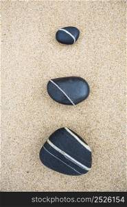 Top view of sea stones over the sand