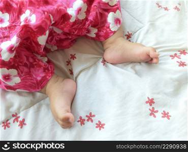 Top view of sleeping female baby feet on sleeping bag, softly focus for interesting image
