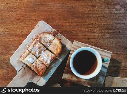 Top View of Sweet Bread Serve on Cutting Board with Hot Tea. Lay on Wooden Table with Copy Space