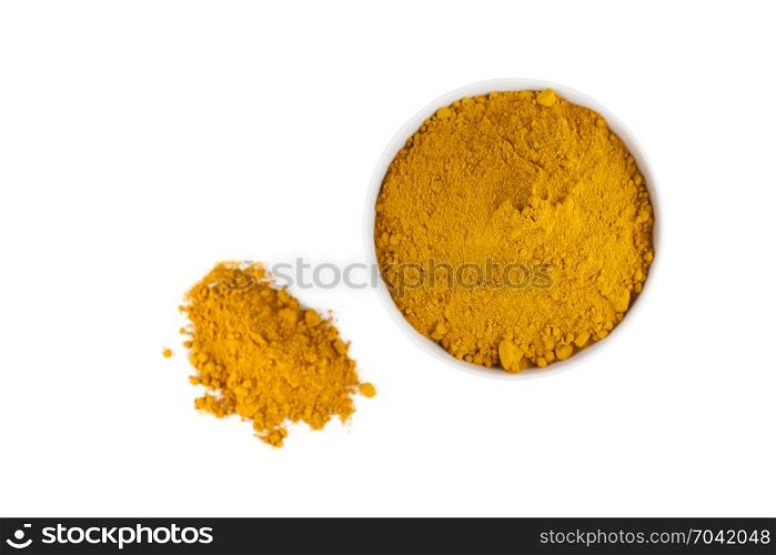 top view of turmeric powder in white ceramic bowl isolated on white background