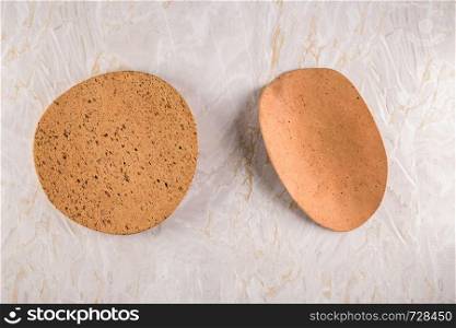 Top view of Two cork plates on a gray marble background with space for text.
