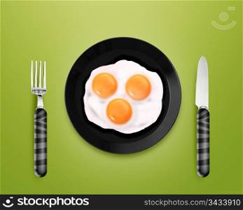 top view of two fried eggs on black Plate between silver knife and fork on gray background.