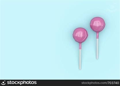 Top view of two pink lollipops on turquoise background