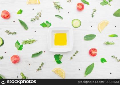 top view of various types of aromatic herb leaves and cut vegetables on wooden background