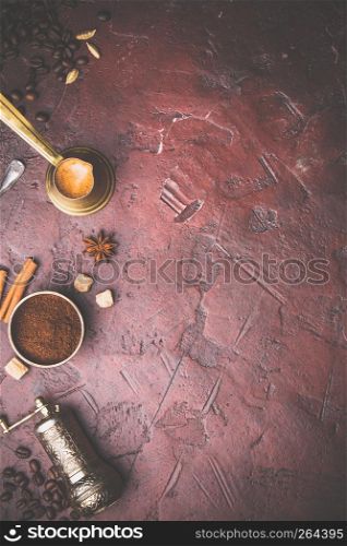 Top view of vintage manual coffee grinder, coffee beans and spices, space for text, red background