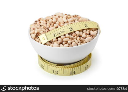 Top view of white kidney bean in cearamic bowl with yellow measuring tape isolated on white background inclouded clipping path and soft shadow