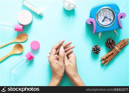 Top view of woman&rsquo;s hands with cosmetic containers, Beauty, skincare and lifestyle concept