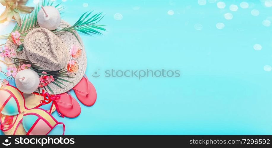 Top view of woman&rsquo;s summer beach accessories: bikini, flip flops, sunglasses, straw hat, creole earrings, with palm leaves and tropical flowers on turquoise blue background, banner with copy space