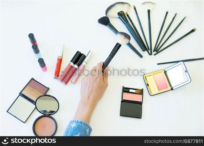 top view of women choosing brush for makeup cosmetic