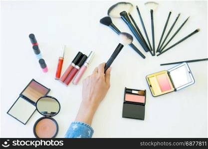 top view of women choosing brush for makeup cosmetic
