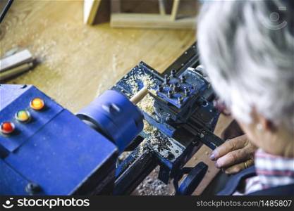 Top view of wooden lathe working in a carpentry. Top view of wooden lathe